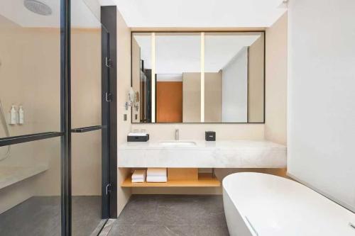 a bathroom with a sink and a large mirror at Fairfield by Marriott Ningde Xiapu in Xiapu