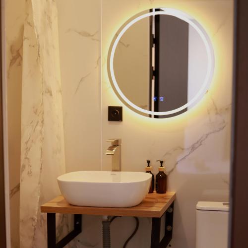 a bathroom with a white sink and a mirror at Hotel Mansuri in Almaty