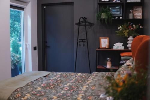 a bedroom with a bed and a blue door at Riverside weekend cabin in Upesciems