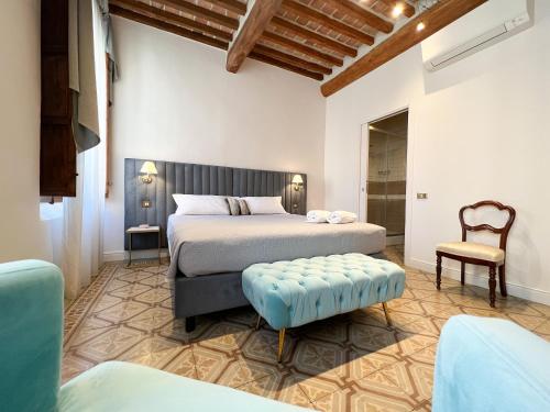 a bedroom with a bed and a chair at Dimora Decò in Lugo