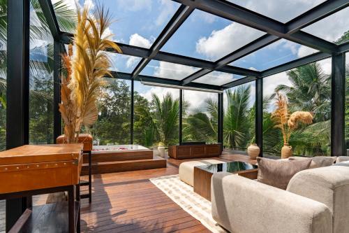 a conservatory with a large glass ceiling at Kanva Ubud in Tegalalang