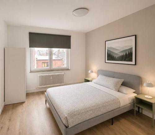 a bedroom with a bed with two tables and two windows at tirou 5 centre - gare - aéroport in Charleroi