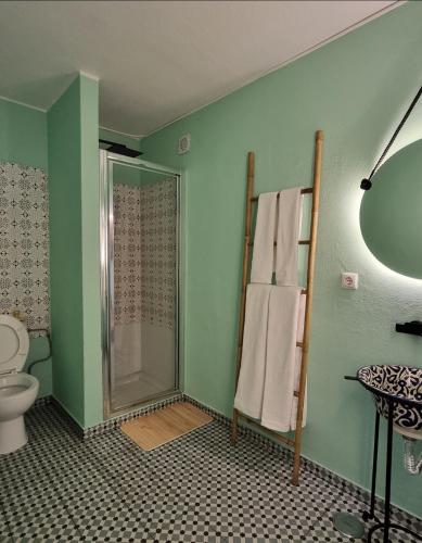 a bathroom with a shower and a toilet and towels at Wonder Charm in Albufeira