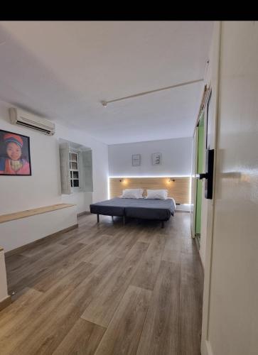 a bedroom with a bed in the middle of a room at Wonder Charm in Albufeira