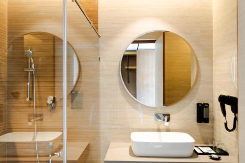 a bathroom with a sink and a mirror at The Shore Trishvam in Pondicherry