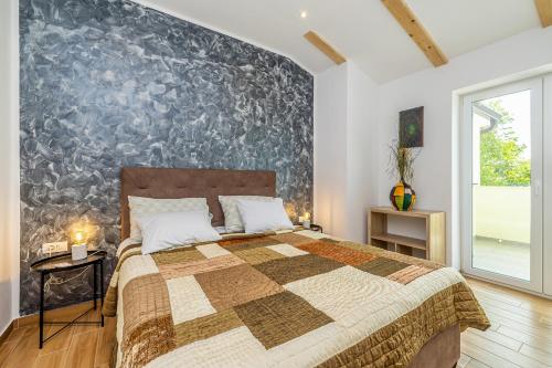 a bedroom with a bed and a large wall at Holiday house MARLY with private pool in Kras