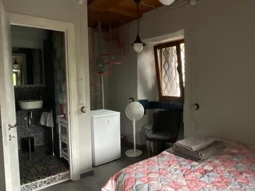 a bedroom with a bed and a chair and a window at Casa Del Signore III in Baveno