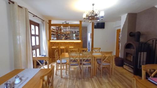 a dining room with a table and chairs and a fireplace at Penzion U kostela Mláka in Mláka