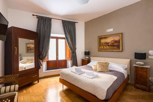 a bedroom with a large bed and a mirror at Trevispagna Charme Apartment Autonomous in Rome