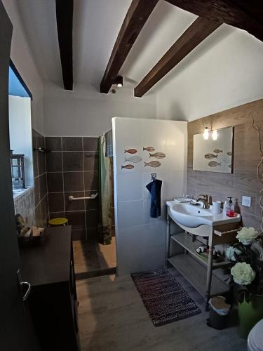 a bathroom with a sink and a shower at La Chaumière en Bellevue in Muzillac
