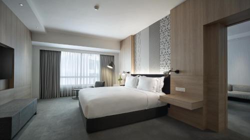 Ein Bett oder Betten in einem Zimmer der Unterkunft G Hotel Gurney