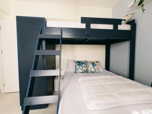 a bedroom with a bunk bed with a ladder at Luxury 2 Bedroom Apartment in Caesar Resort in Iskele