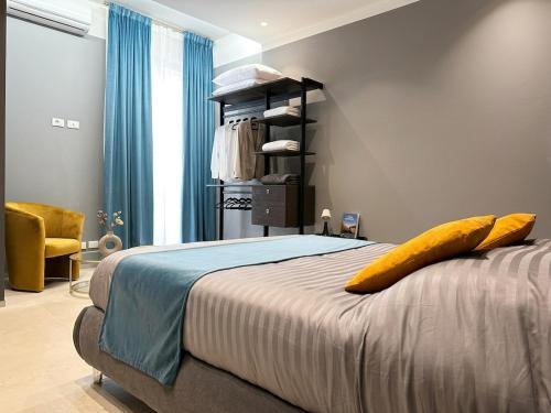 a bedroom with a bed with a yellow pillow on it at Suite Apollinare in Ravenna