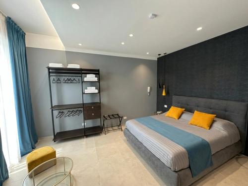 a bedroom with a bed with yellow pillows on it at Suite Apollinare in Ravenna