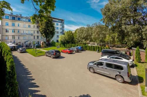a row of cars parked in a parking lot at RigaApartment SoNaDA Self Check-in Aparthotel, Center, Private Parking in Riga