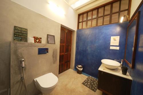 a bathroom with a toilet and a sink at Panackal Heritage Home in Trivandrum