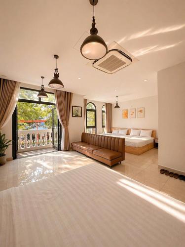 a living room with a bed and a couch at SOLÉRA 2 Homestay in Phú Quốc