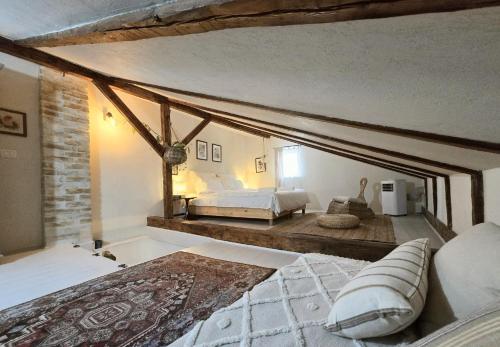 a bedroom with two beds in a room with a stone wall at Casa Horea 54 in Cluj-Napoca
