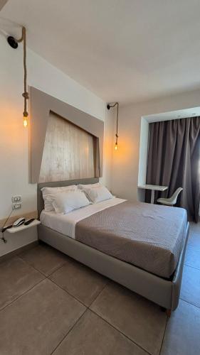 a bedroom with a bed and a chair in it at Favorite Room&Spa in San Giuseppe Vesuviano