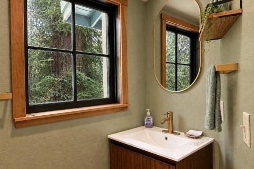 a bathroom with a sink and a mirror and a window at Boho Burrow in Monte Rio