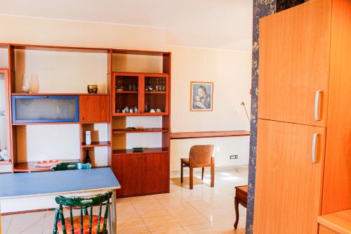 a kitchen with wooden cabinets and a blue counter at B&B Ad Un Passo Dal Mare in Montesilvano