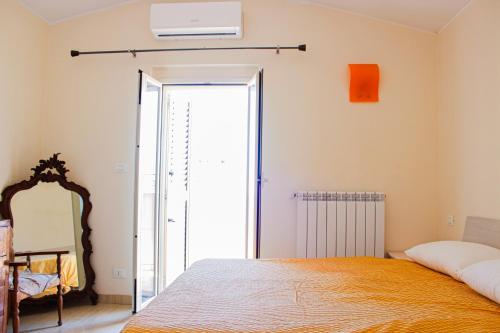 a bedroom with a bed and a mirror at B&B Ad Un Passo Dal Mare in Montesilvano