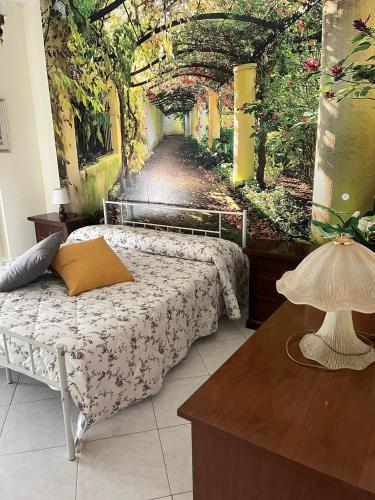 a bedroom with a bed with a painting on the wall at CASA NINETTA in Bari