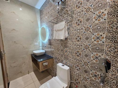 a bathroom with a toilet and a sink at Hotel LimeStarow in Bijni