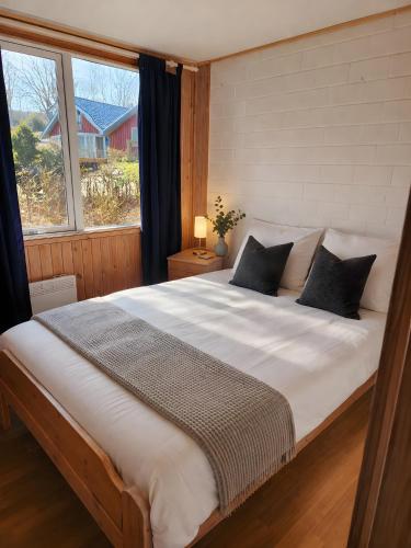 a large bed in a bedroom with a large window at Extertal Ferienpark Sauna Wald 51 in Extertal