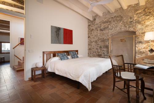 a bedroom with a bed and a desk in a room at LETS HOLIDAYS NICE HOUSE CLOSE to the CASTLE in Tossa de Mar