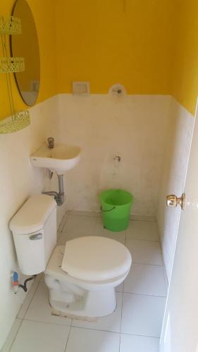 a bathroom with a toilet and a sink at Guanna's Place Room and Resto Bar in Malapascua Island