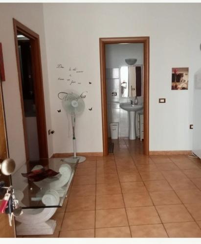 a bathroom with a glass table and a sink at Casa Arborea in Sennori
