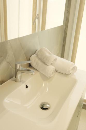 a bathroom sink with towels on top of it at Hotel Mariblu in Rimini