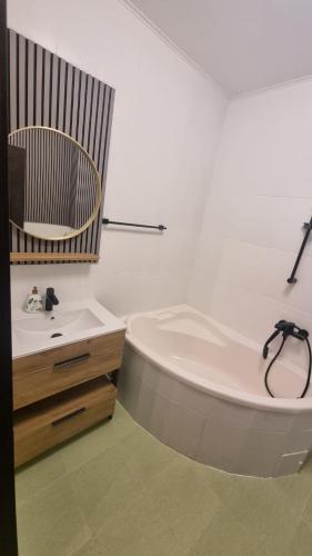 a white bathroom with a tub and a sink at Scandinavian Studio Bucharest in Dudu