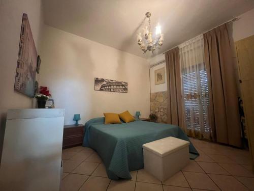 a bedroom with a green bed and a chandelier at Sicily Summer in Nunziata