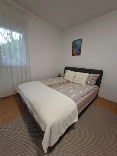 a bedroom with a bed in a room with a window at Una Vibe Studio in Bosanska Krupa
