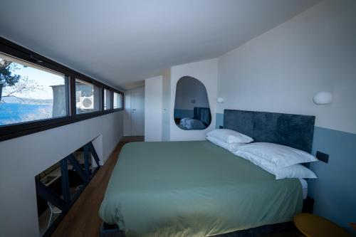 a bedroom with a large bed and a window at Lagò-Anguillara Sabazia in Anguillara Sabazia