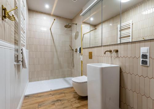 a bathroom with a toilet and a shower and a sink at Gościniec in Sopot