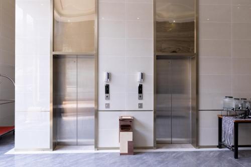 a row of elevators in a wall in a building at Mecon Hotel in Phnom Penh