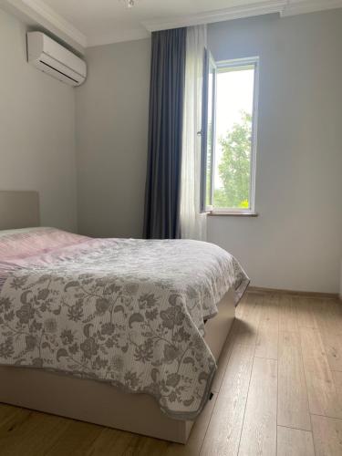 a bedroom with a bed and a window at Zurkas’ guesthouse in Batumi