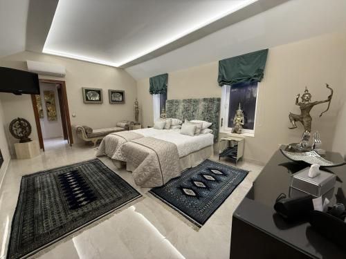 a bedroom with a bed and a living room at Villa Turrion in Marbella