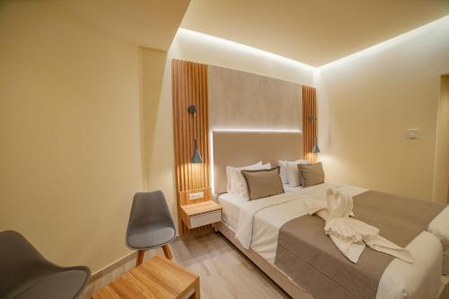 a hotel room with a bed and a chair at Rhodos Horizon Marina - Adults Only in Rhodes Town