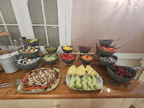 a table topped with bowls of different types of food at Hotel Pension Museum in Vienna