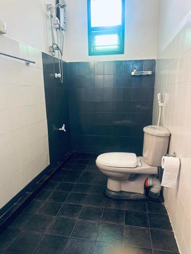 a bathroom with a toilet and a shower at Rock Hill Hotel in Galle