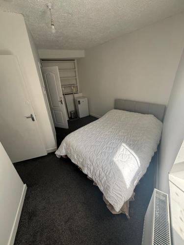 a bedroom with a bed with a white comforter at Kinsale central 5 in Kinsale