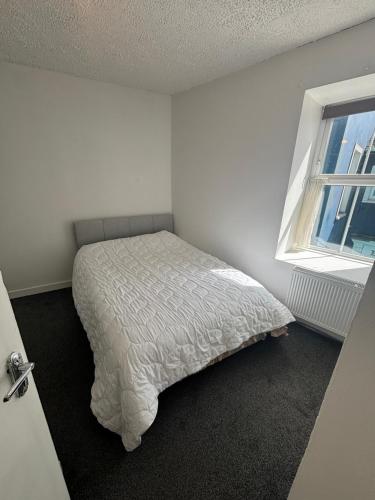 a bedroom with a bed and a window at Kinsale central 5 in Kinsale