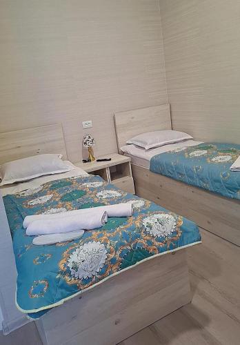two beds sitting next to each other in a room at Oasis in Akhaltsikhe