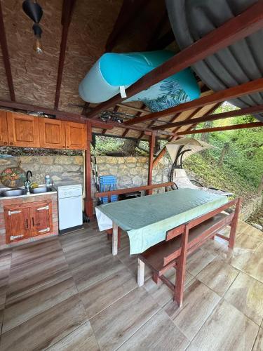 a kitchen with a table and a sink at Zmajeva Kuca in Mali Zvornik