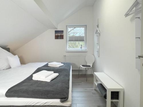 a bedroom with a bed and a desk and a window at Fewo Diemelsee 5 in Heringhausen