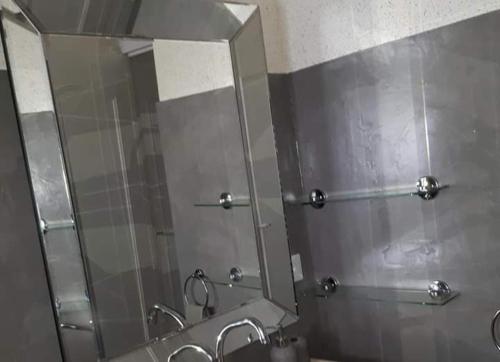 a bathroom with two sinks and a large mirror at Gite Bleu Brittany near Dinan in Plumaudan